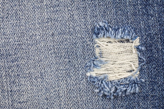 Premium Photo | Denim torn blue jeans texture.