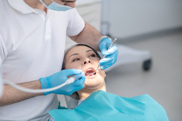 Premium Photo | Dental filling. dentist working on patients teeth ...