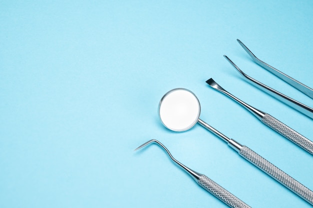 Premium Photo | Dental tools on blue background. medical technology ...