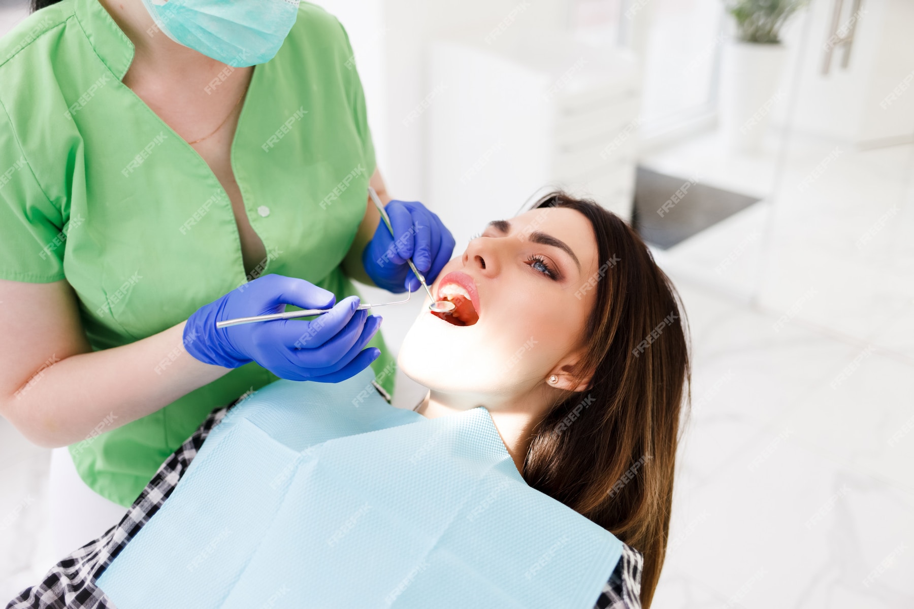 Premium Photo | Dentist doing dental checkup for his patient