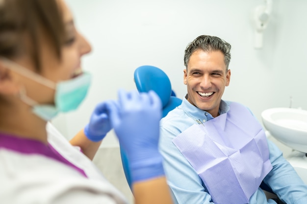 Premium Photo | Dentist And Patient Interacting And Smiling.