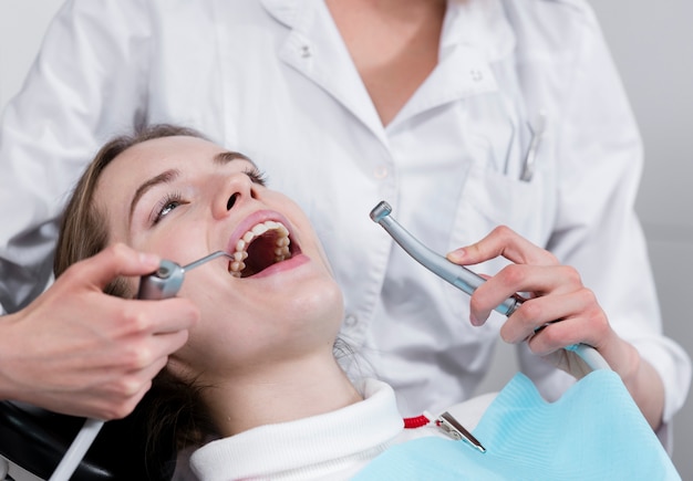 Dentist performing teeth treatment Free Photo