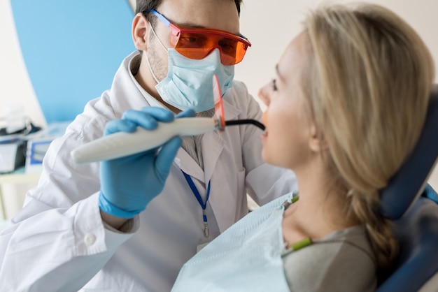 Premium Photo | Dentist taking care of patient tooth