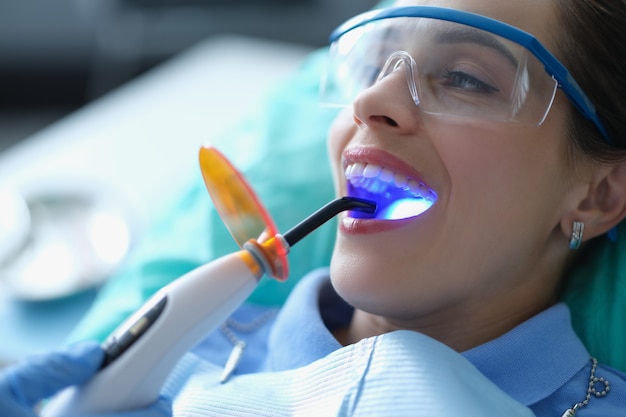 Premium Photo | Dentist using dental ultraviolet curing light tool ...