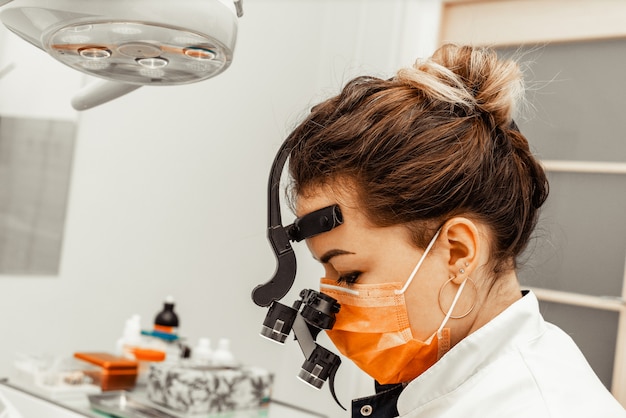 Dentist Young Woman Treats A Patient A Man The Doctor Uses Disposable