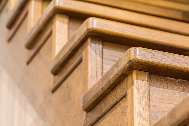 Detail close-up image of wooden oak stairs in house interior Premium Photo