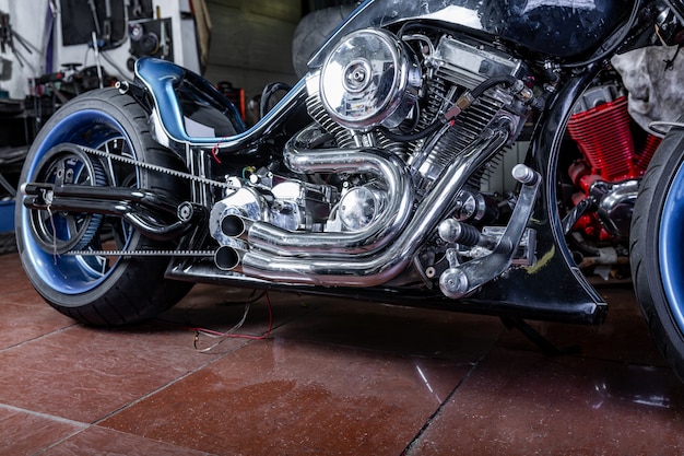 Detail on a modern motorcycle in the workshope. motorcycle exhaust. Premium Photo