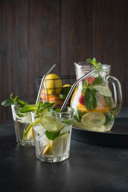 Premium Photo Detox Lemonade With Lime Orange Lemon Strawberry In Glass And Jar