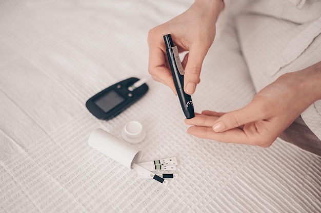 Premium Photo | Diabetes checking blood sugar level. woman using ...