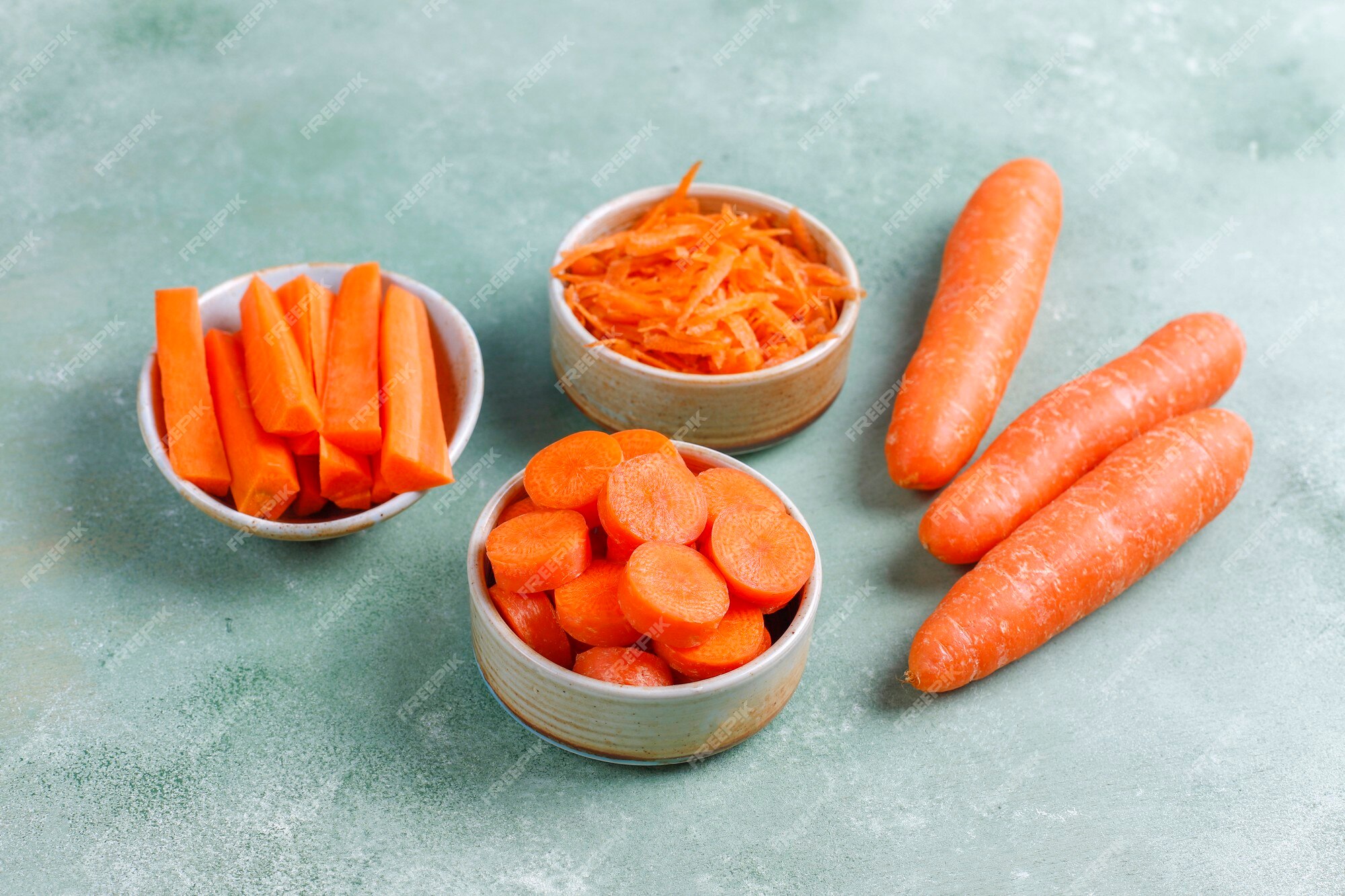 Free Photo | Different cuts of carrot in bowls.