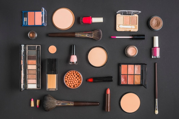 Different type of makeup products on black backdrop Free Photo