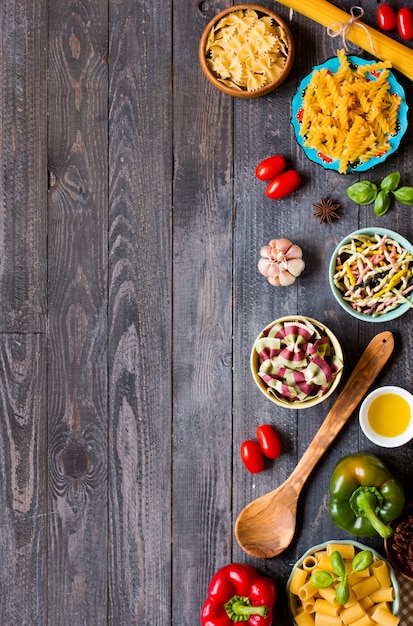 Different types of pasta with various types of vegetables, health or vegetarian concept, top view Premium Photo