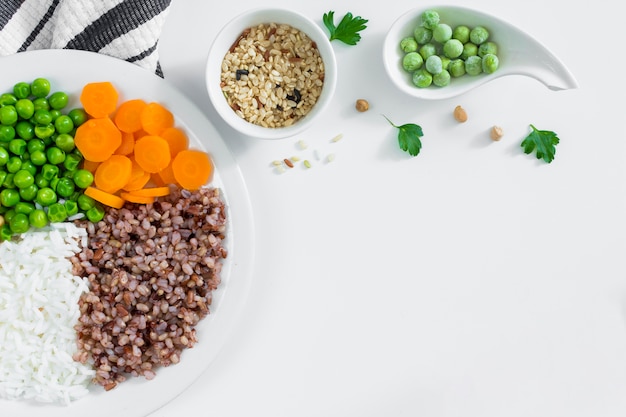 Premium Photo | Different types of porridge with vegetables on white plate