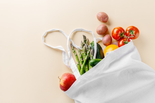 Different vegetables in textile bag on beige Free Photo