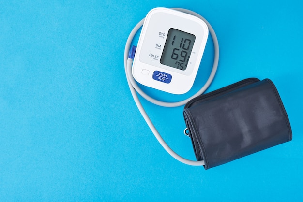 Premium Photo | Digital blood pressure monitor on blue background ...