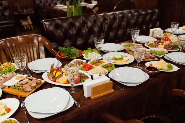 Dinner table setup with delicious food ready to be served | Free Photo