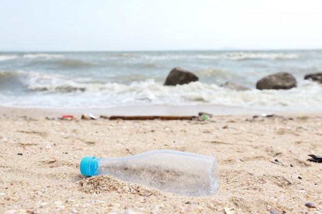 Premium Photo | Dirty beach filled with plastic pollution, garbage and ...