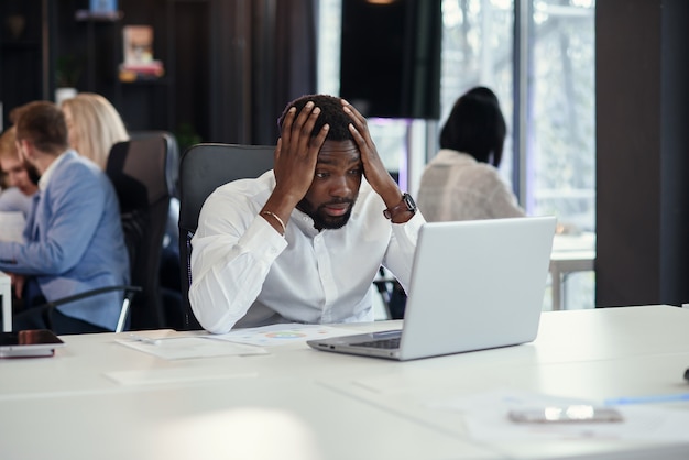 Premium Photo | Disappointed african american office manager looking on ...