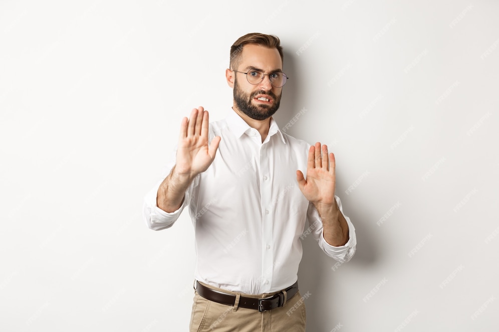 Free Photo Displeased Man Rejecting Something Disturbing Showing Stop Sign And Declining 5568