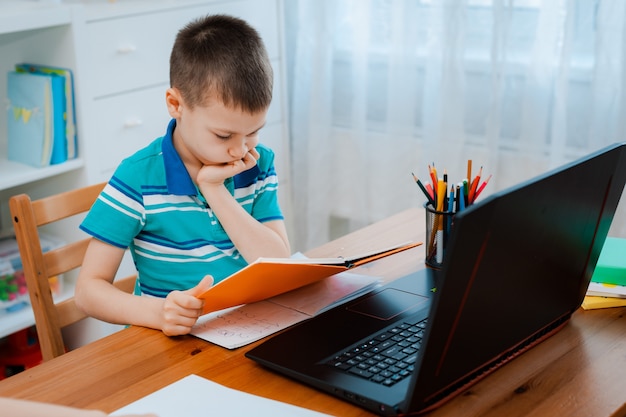 Premium Photo | Distance learning online education. a schoolboy boy ...