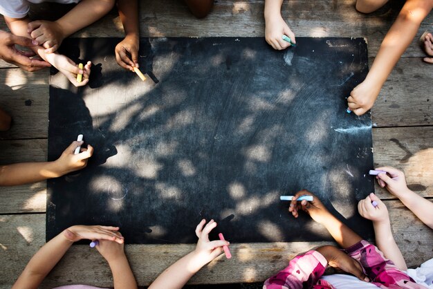 Premium Photo | Diverse group of kids drawing on a blackboard