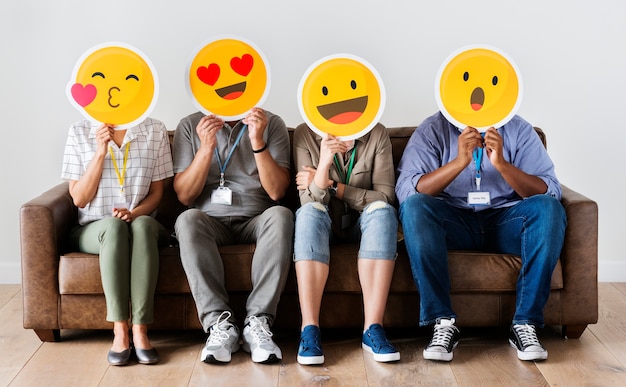 Premium Photo | Diverse people sitting and covering face with emojis boards