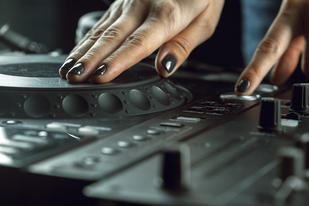Dj playing music at mixer closeup Premium Photo