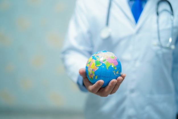 Premium Photo | Doctor holding a globe