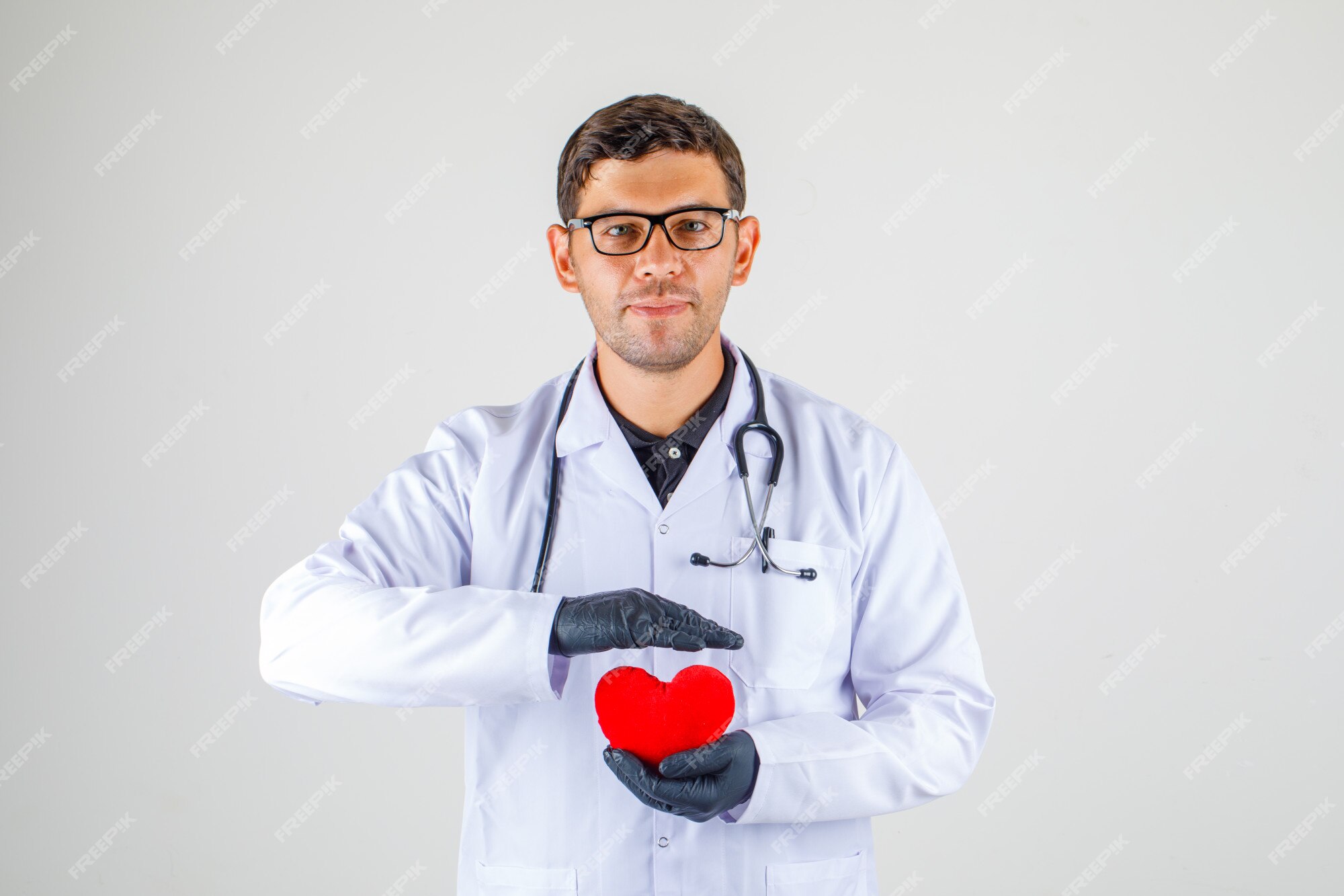 Free Photo | Doctor holding heart in white coat with stethoscope and ...