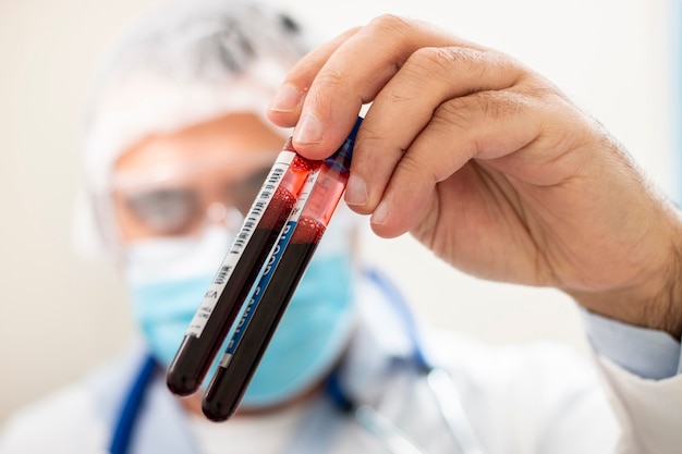 Premium Photo | Doctor holding test tube blood sample