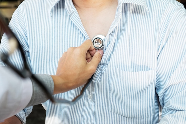 Free Photo | Doctor listening to cheerful young patients chest with ...