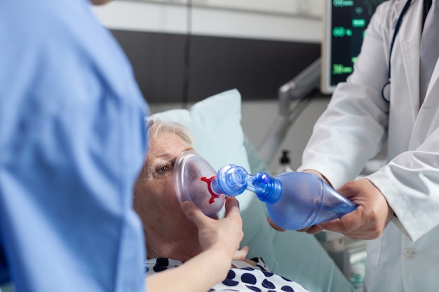 Premium Photo | Doctor and nurse helping sick hospitalized senior woman ...