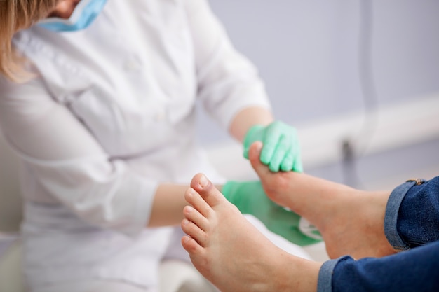 Doctor, the podiatrist examines the foot Premium Photo