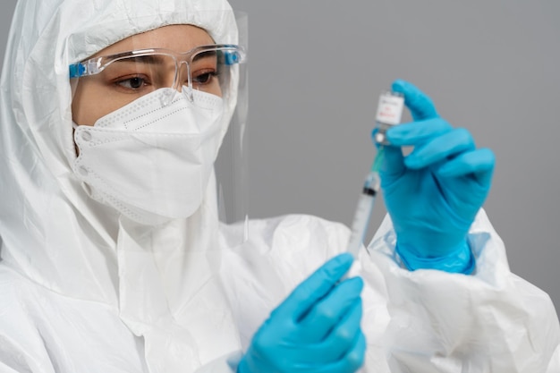 Premium Photo | Doctor in protective ppe suit drawing coronavirus ...