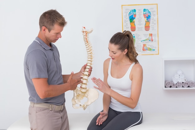 premium-photo-doctor-showing-anatomical-spine-to-his-patient