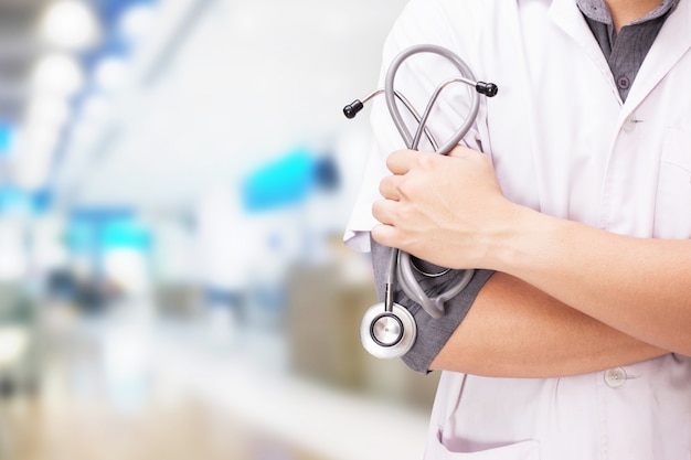 Doctor with a stethoscope in the hands and hospital background Free Photo