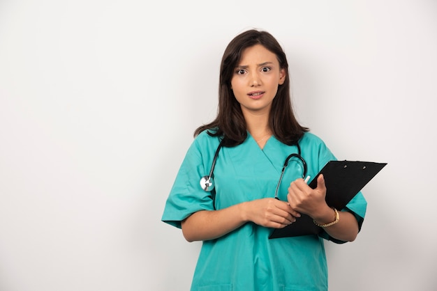 Free Photo | Doctor with stethoscope and clipboard looks ...