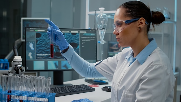 Premium Photo | Doctor working in science laboratory with test tubes