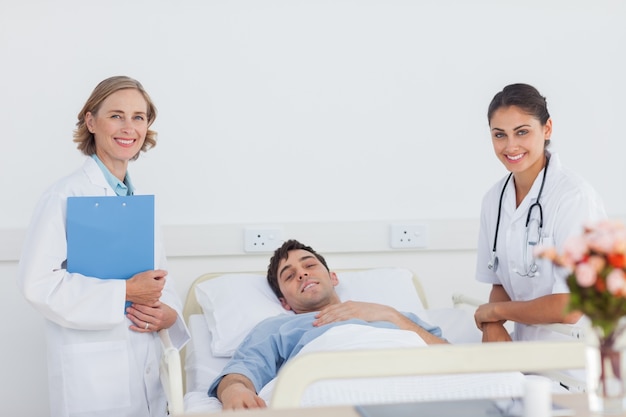 Premium Photo | Doctors and patient looking at the camera