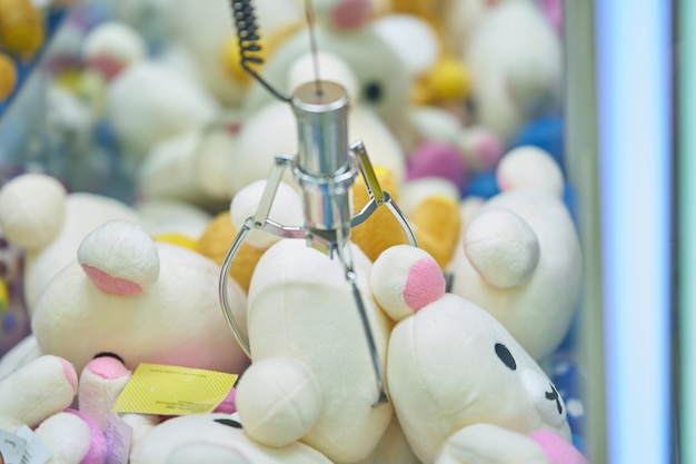 Doll picker or claw clamp machine in game arcade,clamping doll Premium Photo