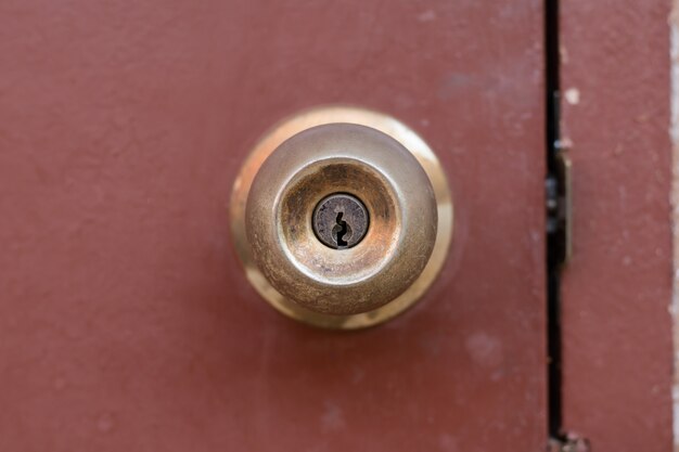 Door Knob And Keyhole Made Of Brass On The Old Wooden Door Photo