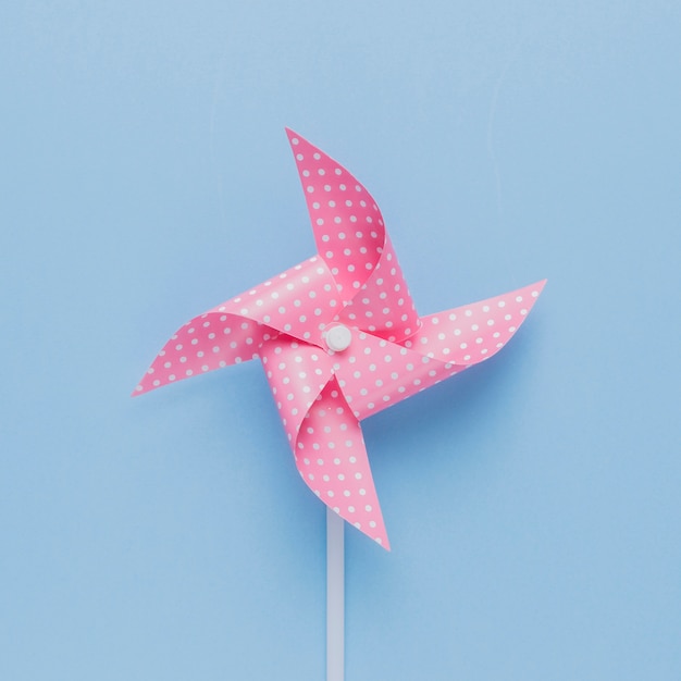 Premium Photo | Dotted pink pinwheel on blue background