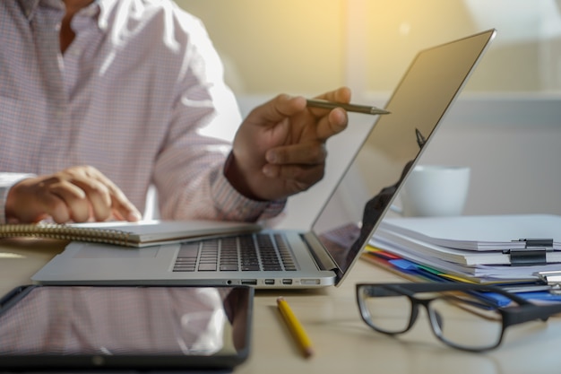Double exposure of business man hand working on laptop computer on wooden desk with social media network diagram Premium Photo
