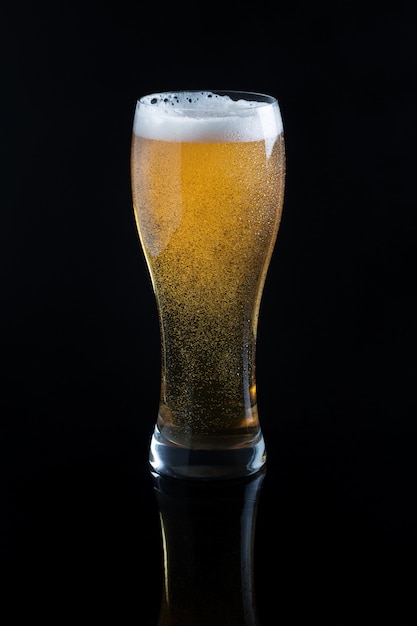 Draft beer in glass on black Photo | Premium Download