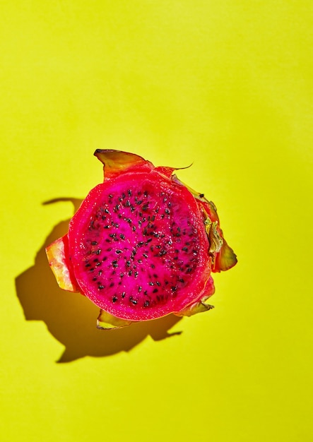 Premium Photo | Dragon fruit - pitahaya cut into pieces on a yellow ...