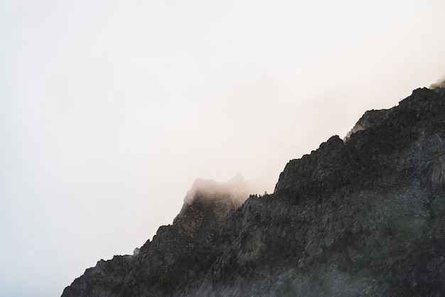 Premium Photo | Dramatic bleak fog among giant rocky mountains