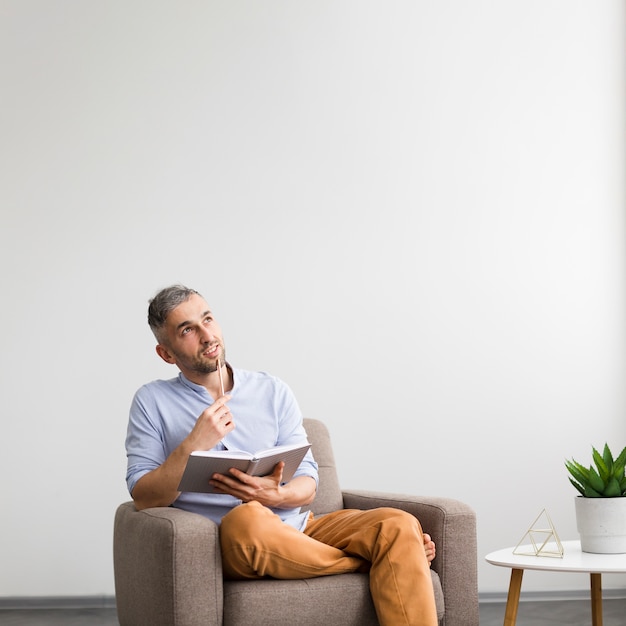 Dreamy man thinking about what to write Free Photo