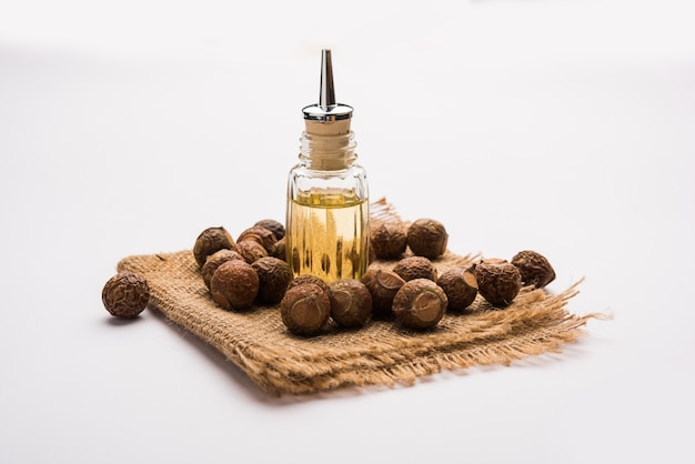 Premium Photo | Dried raw shikakai and reetha or soapnut powder in a ...