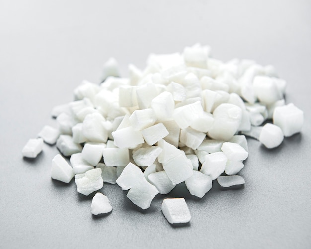 Premium Photo | Dried sweet coconut cubes on a white background.