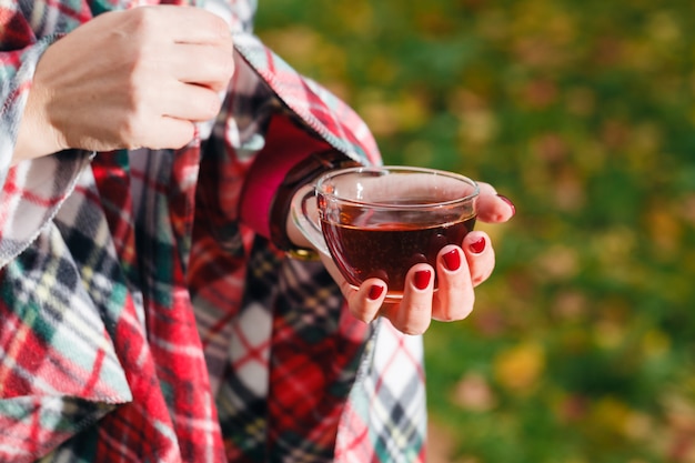 Drink hot tea and walking outdoor in autumn forest Premium Photo